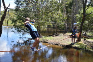 Students crossing rope bridge in Adventure Race