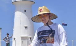 Student in front of lighthouse