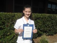 Abby with her certificate of high distinction
